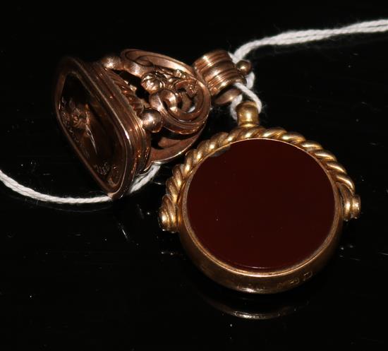 An early 20th century 15ct gold, carnelian and bloodstone spinning fob and a gold and citrine fob seal with carved matrix.